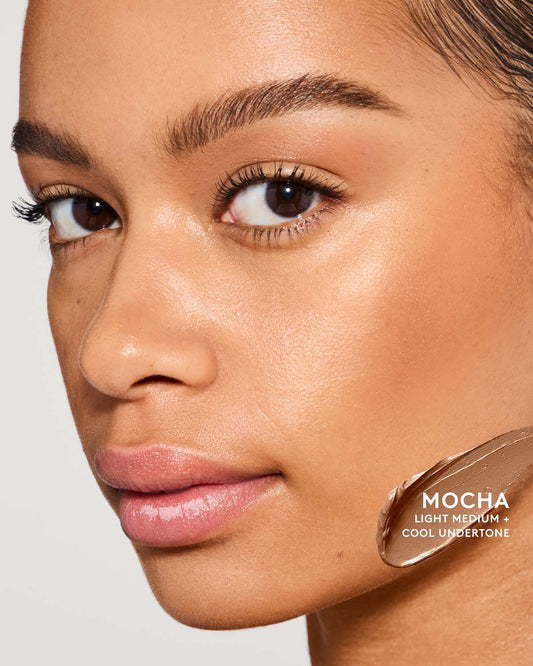 Medium skin toned model wearing match sti contour in shade mocha.