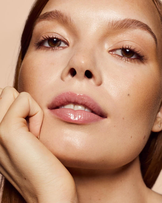 light skin tone model wearing Gloss Bomb Heat Universal Lip Luminizer + Plumper in shade Lemon Lava