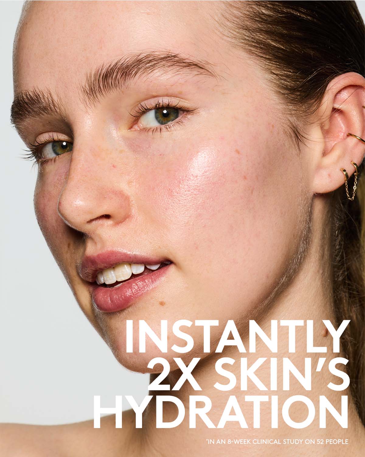 Close-up of a person's face with text about skin hydration on a plain background