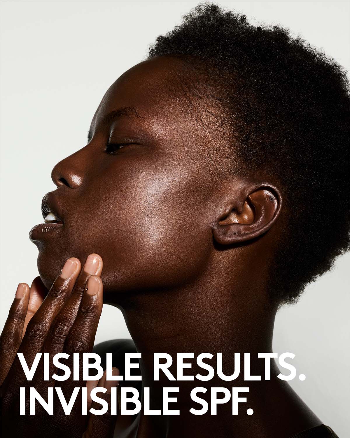 Person with invisible SPF text on a neutral background