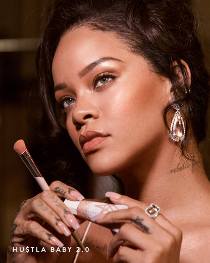 Rihanna wearing Fenty Beauty Liquid Killawatt Fluid Freestyle Highlighter and holding product
