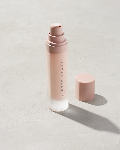 Fenty pro filter instant retouch primer with the lid off standing on a gray background