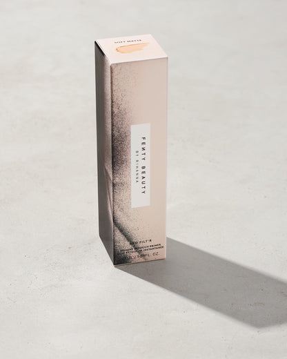Fenty pro filter instant retouch primer packaging on a gray background