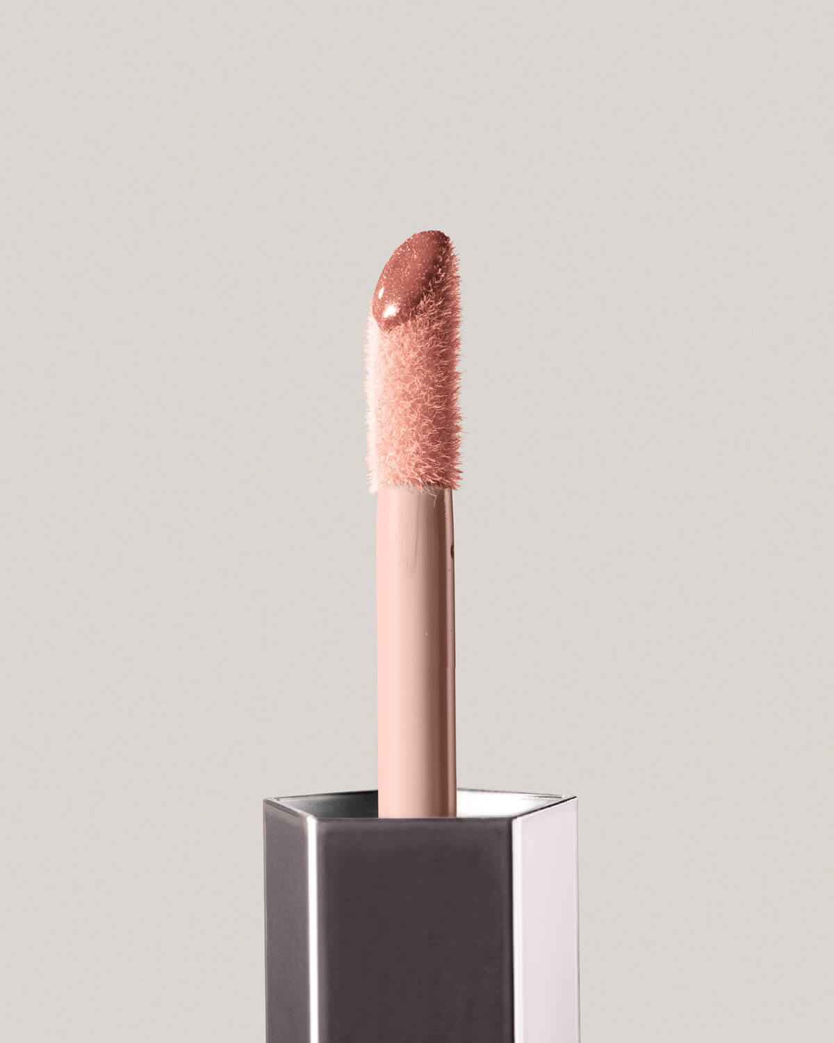 Fenty Beauty GLOSS BOMB UNIVERSAL LIP LUMINIZER in shade Fenty Glow close up of doe foot applicator