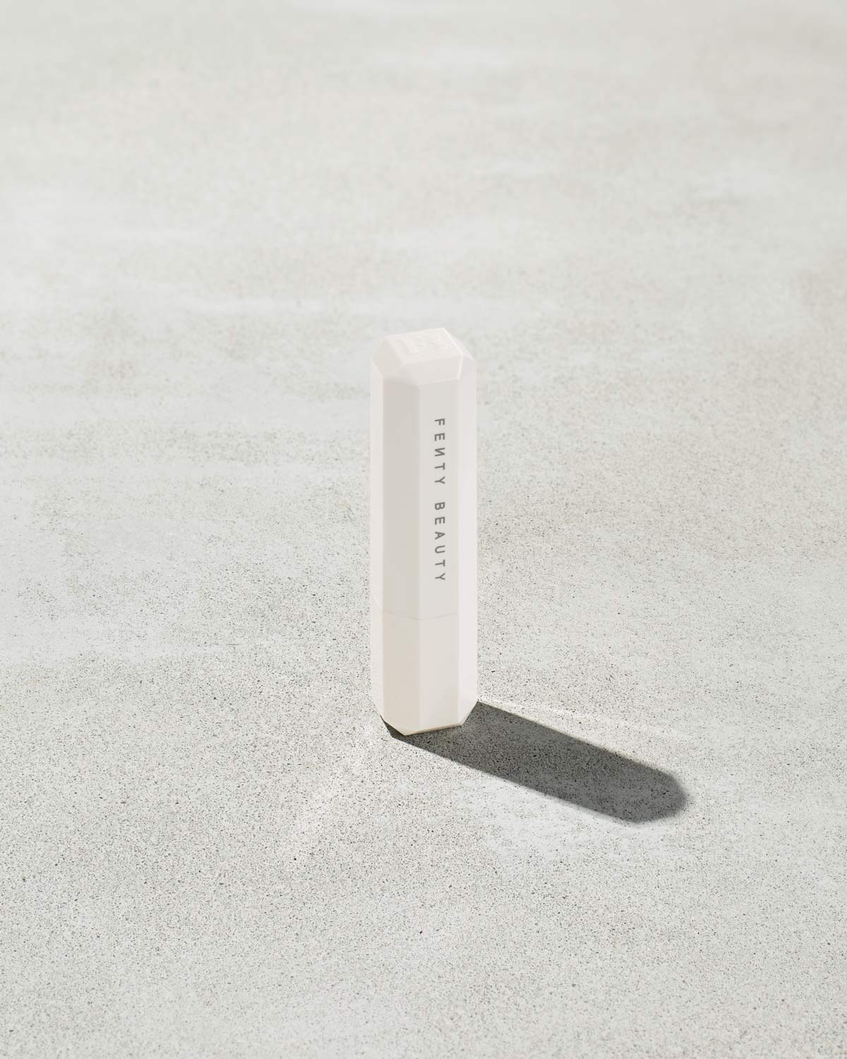 Packaging of Pro Kiss'r Lip-Loving Scrubstick, featuring a very light pink color with the prominent "Fenty Beauty by Rihanna" branding.