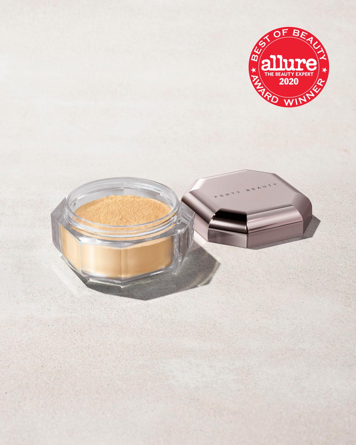an open jar of mini setting powder, with the lid to one side, laid against a gray background and the Allure "Best of Beauty" award stamp overimposed