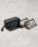 One black rectangular and two triangular clear bags with Fenty branding on a gray background
