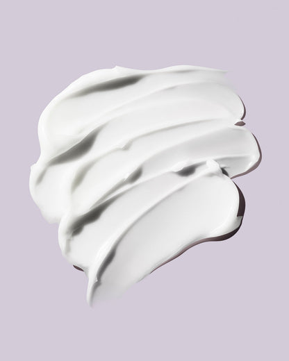 A smear of Butta Drop Whipped Oil Body Cream with Tropical Oils + Shea Butter on a lilac background.