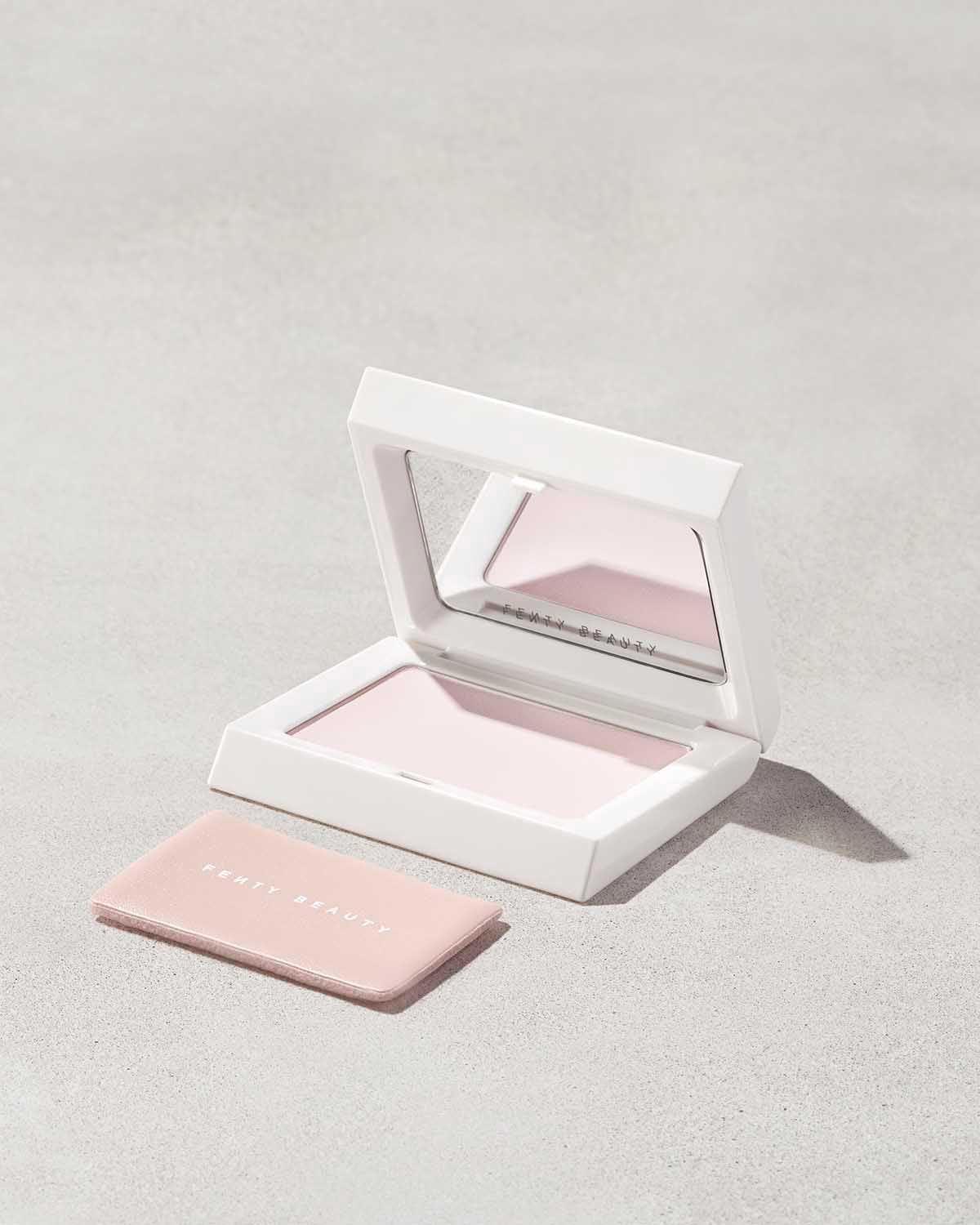 Open compact of the Invisimatte Setting Powder and sponge on a light background.