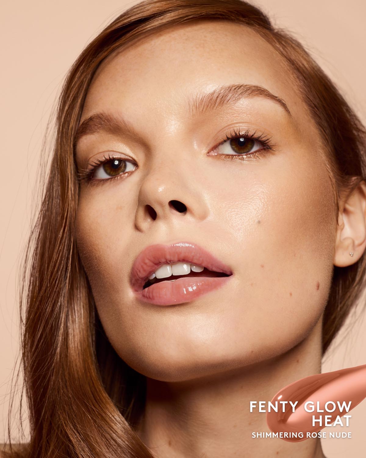 Close-up beauty shot of a woman with glossy nude lips and warm peach-toned skin, with the text 'FENTY GLOW HEAT' and 'SHIMMERING ROSE NUDE' in the lower right corner.