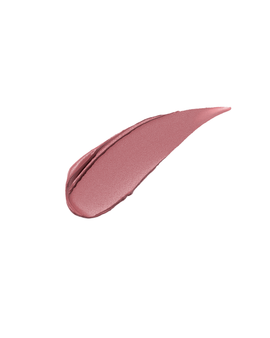 A smear of Fenty Icon Velvet lipstick in light pink color on a light background.