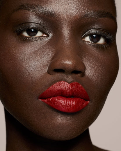 deep skin toned model wearing stunna lip paint in the shade uncensored