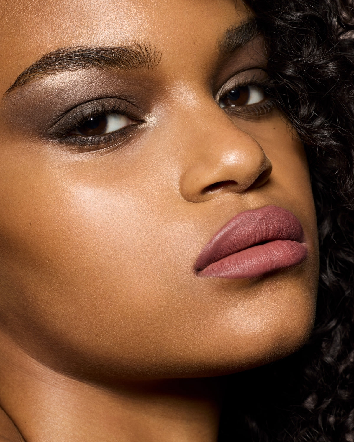 medium skin toned model wearing stunna lip paint in the shade uncuffed