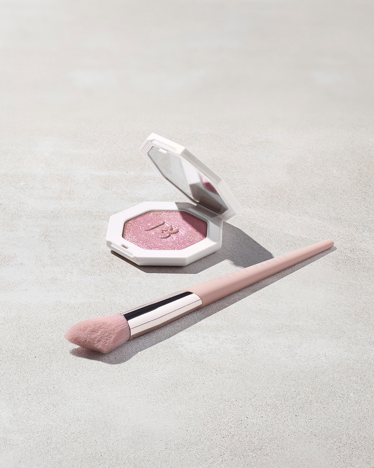 Killawatt Freestyle Highlighter shown in shade Wattabrat with cheek hugging highlight brush