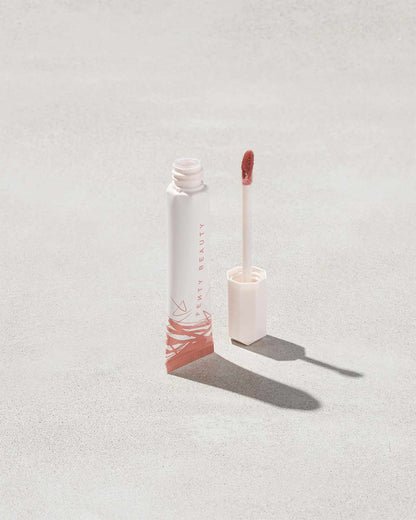 Open tube of Pro Kiss'r Luscious Lip Balm in shade Latte Lips on grey background.
