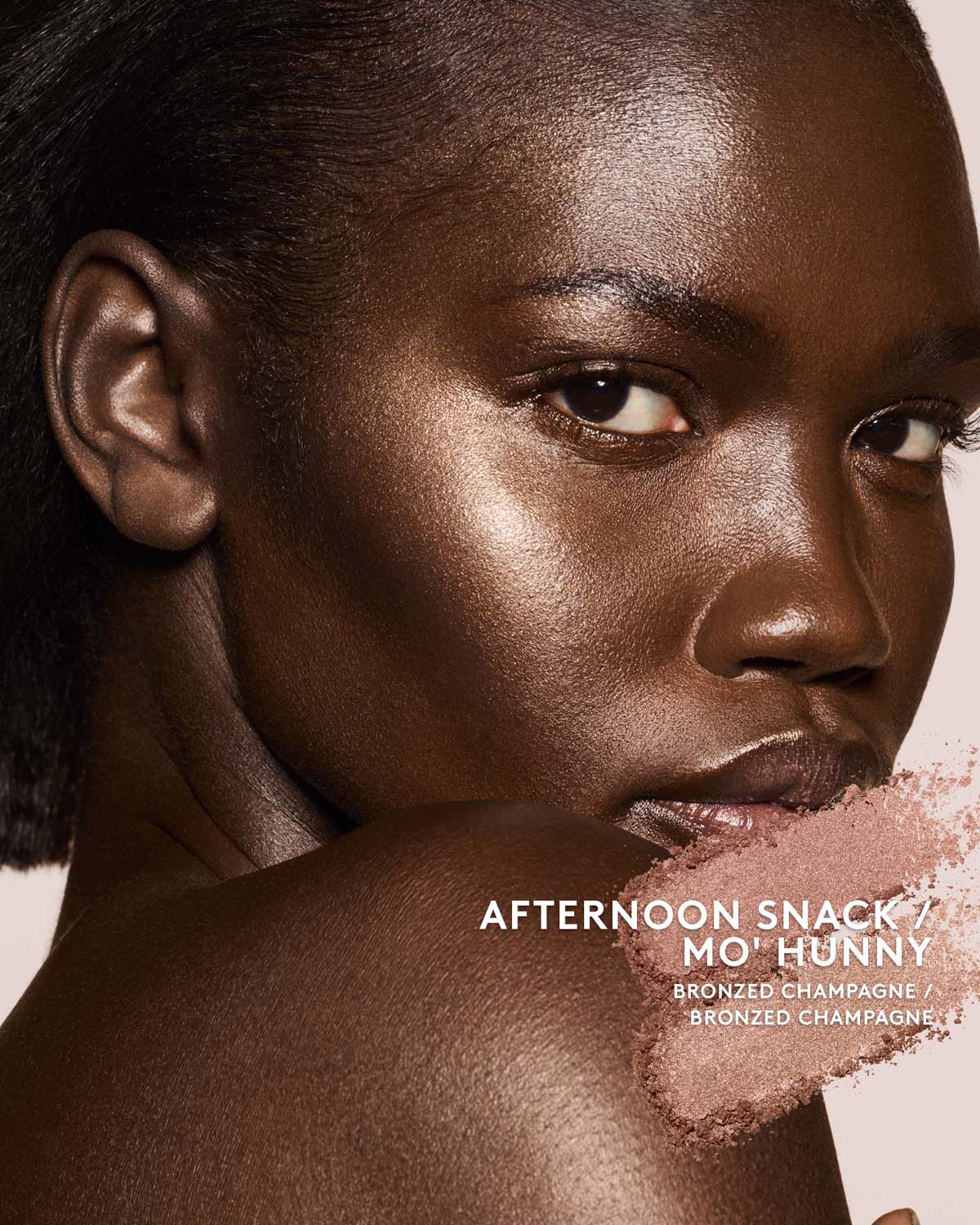 deep skin toned model wearing killawatt freestyle highlighter in shade afternoon snack/mo hunny