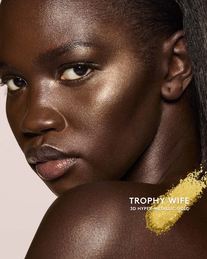 deep skin toned model wearing killawatt freestyle highlighter in shade trophy wife