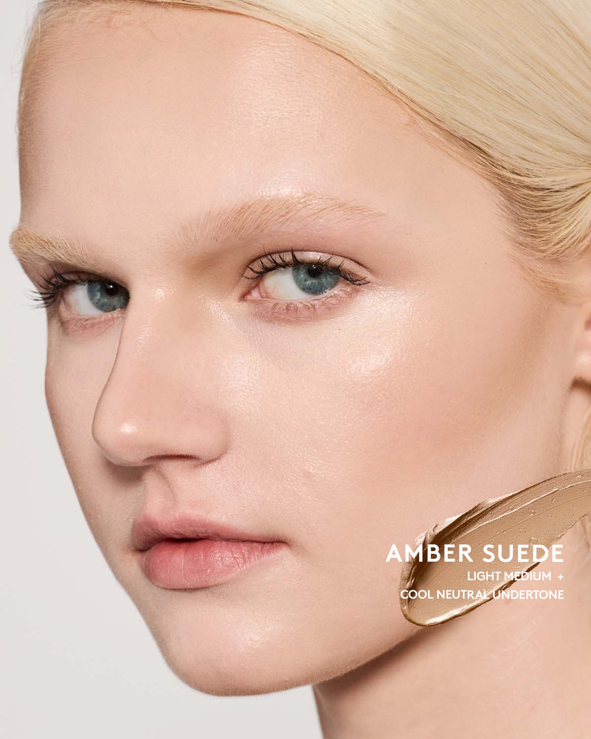 Light-medium skin toned model wearing match stix contour in shade amber suede.