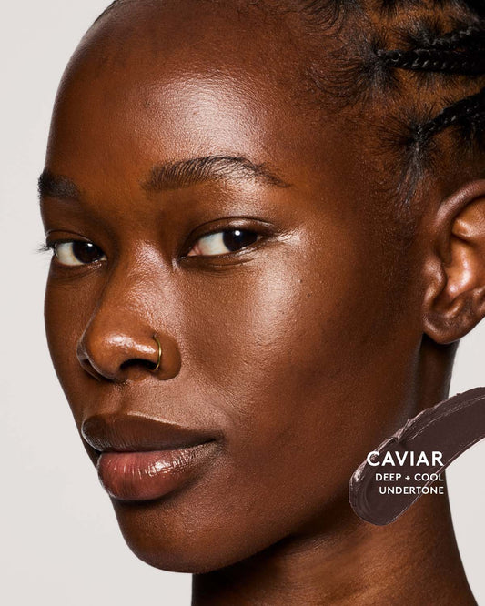 Deep skion toned model wearing match stix contour in caviar.