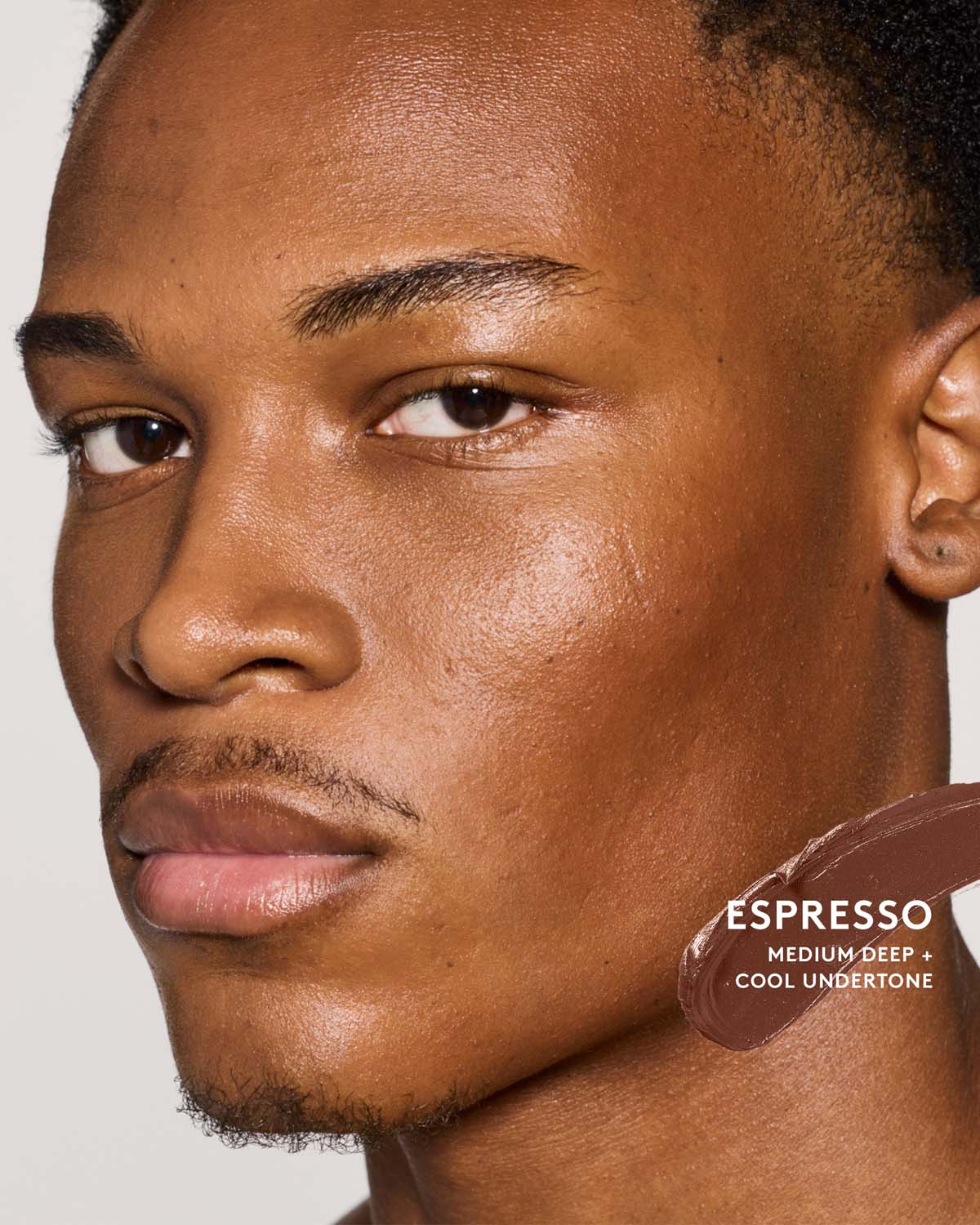 Medium-deep skin toned model wearing match stix contour in espresso.