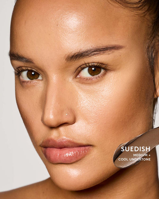 Medium skin tone model wearing suedish match stix contour.