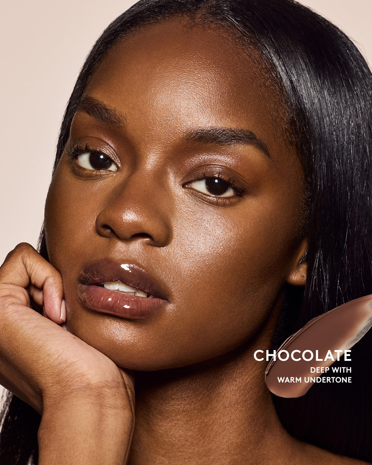 Deep skin tone model wearing cheeks out bronzer in shade chocolate.