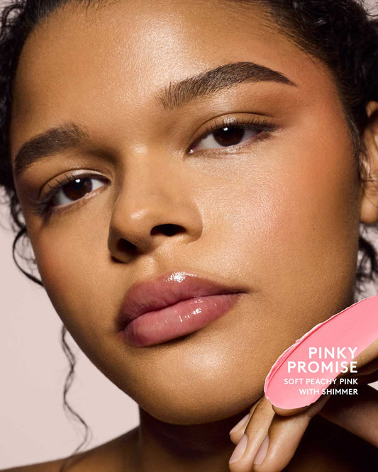 medium skin toned model wearing cheeks out freestyle cream blush in shade pinky promise