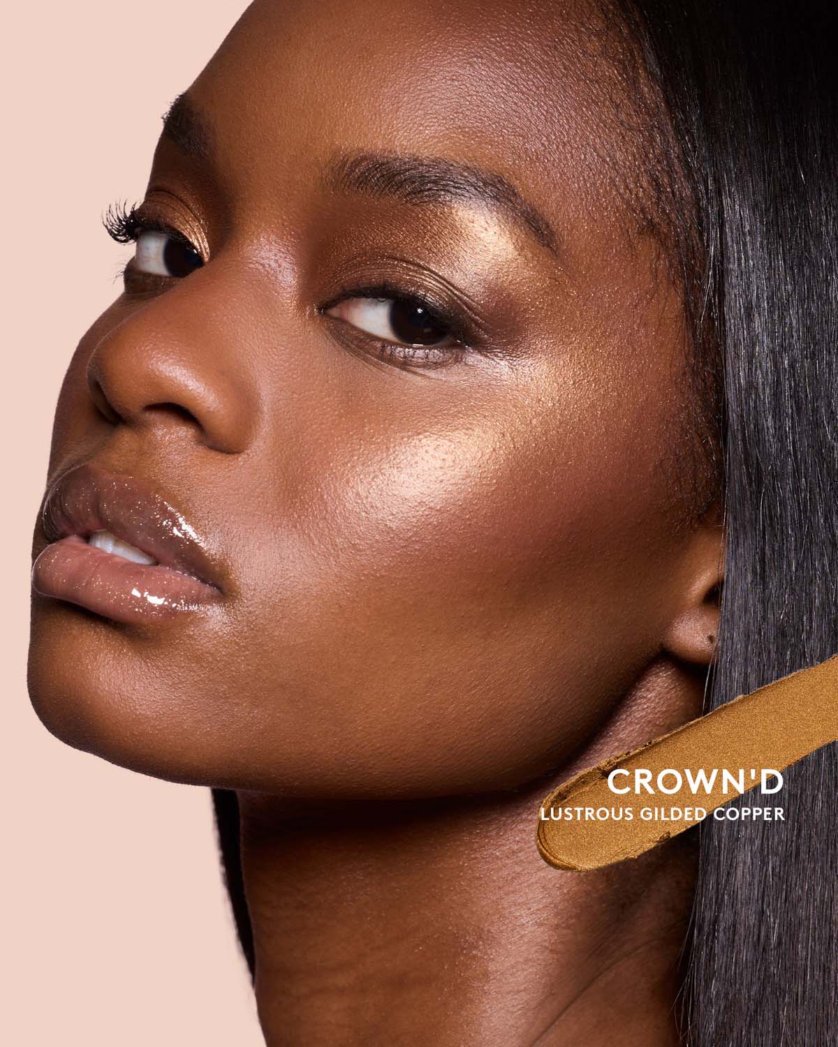Deep skin toned model wearing match stix shimmer in shade crown'd.