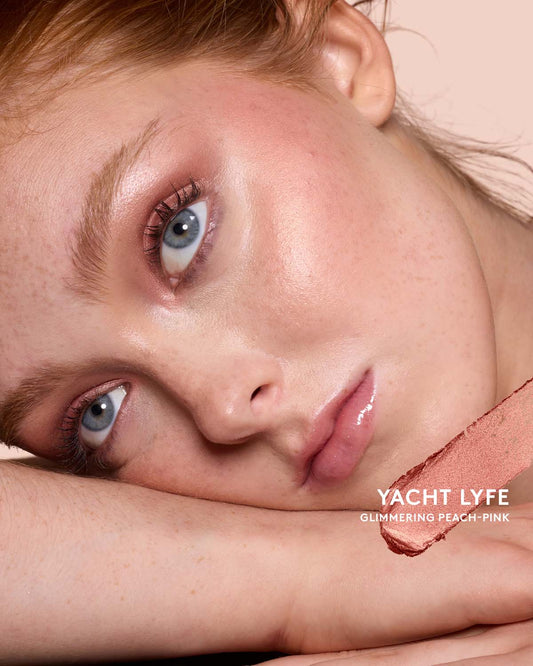 Light-medium skin toned model wearing match stix shimmer in shade Yacht Lyfe.