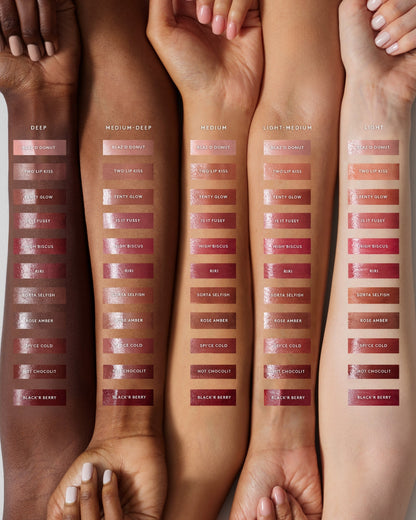 Arm swatch of Gloss Bomb Stix High-Shine Gloss Stick line against Deep, Medium Deep, Medium, Medium-Light, and Light skin tones