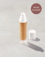 An open bottle of a new shade of Pro Filt'r Soft Matte Longwear Foundation in the shade 335 on a grey background.