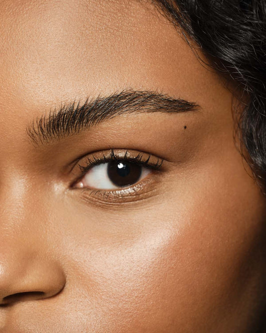 medium skin toned model wearing brow wax