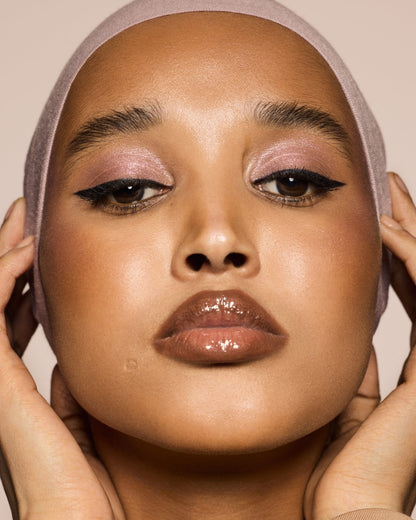 medium skin toned model wearing flypencil in shade cuz i'm black