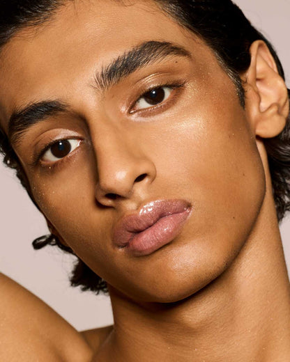 medium skin toned model wearing gloss bomb universal lip luminizer in Fu$$y