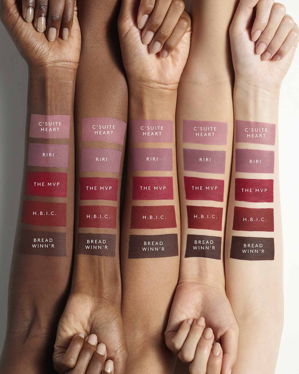 Arms of five models with different skin tones showing the Fenty Icon Velvet lipstick shades on each arm.
