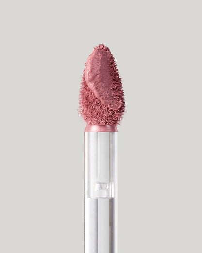 Close-up of of a Fenty Icon Velvet lipstick wand on a light background.