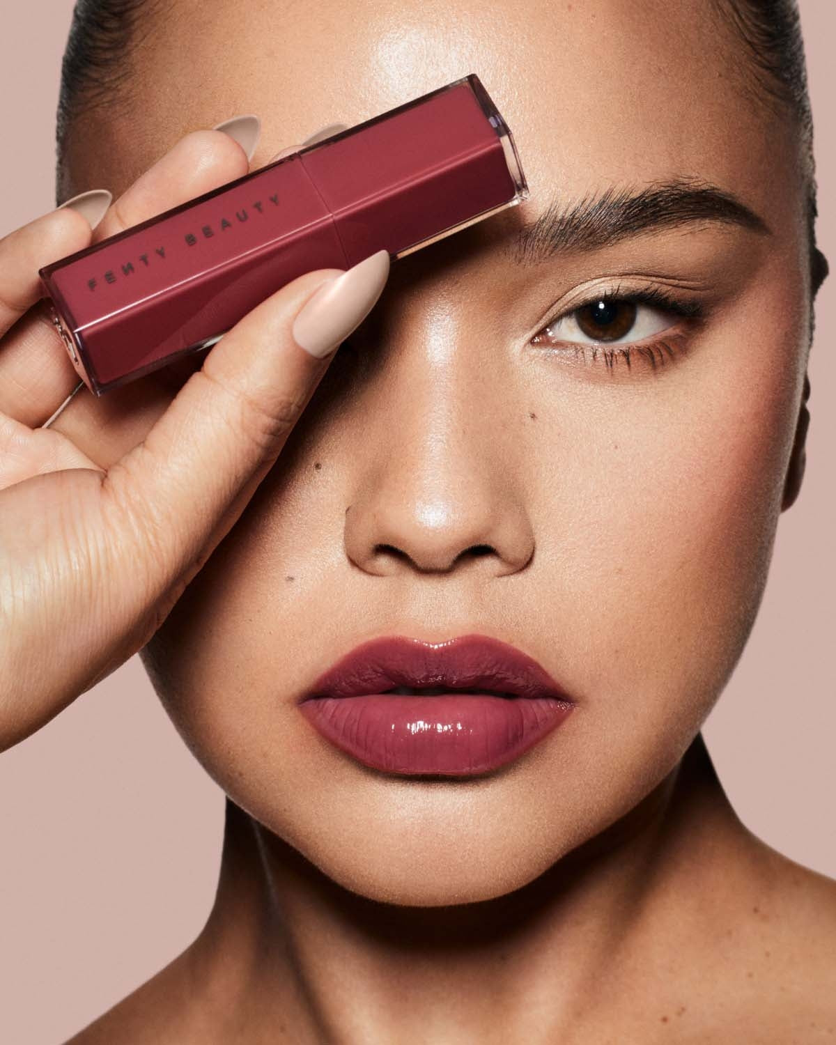 Model in Pro Filt'r shade 498 wearing Gloss Bomb Stix Lip Gloss Stick in shade Riri.