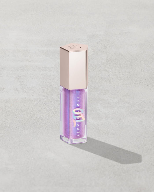 Gloss Bomb Oil Luminizing Oil and Gloss in shade Miss Jellyfish product against a concrete background.