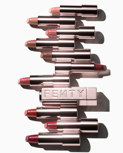 The 10 Fenty Icon lipstick shades displayed in open cases with a metallic refillable lipstick holder.