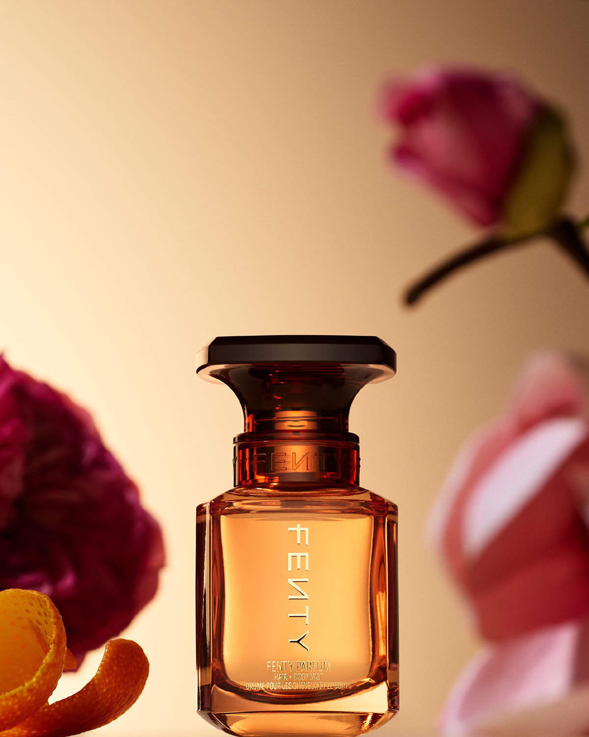 Fenty Parfum Hair + Body Mist with fragrance notes in the background.