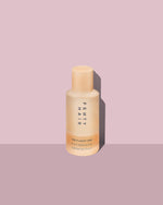 Fenty Hair product bottle on a pink background