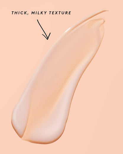 smear of fat water on a peach background noting its thick, milky texture