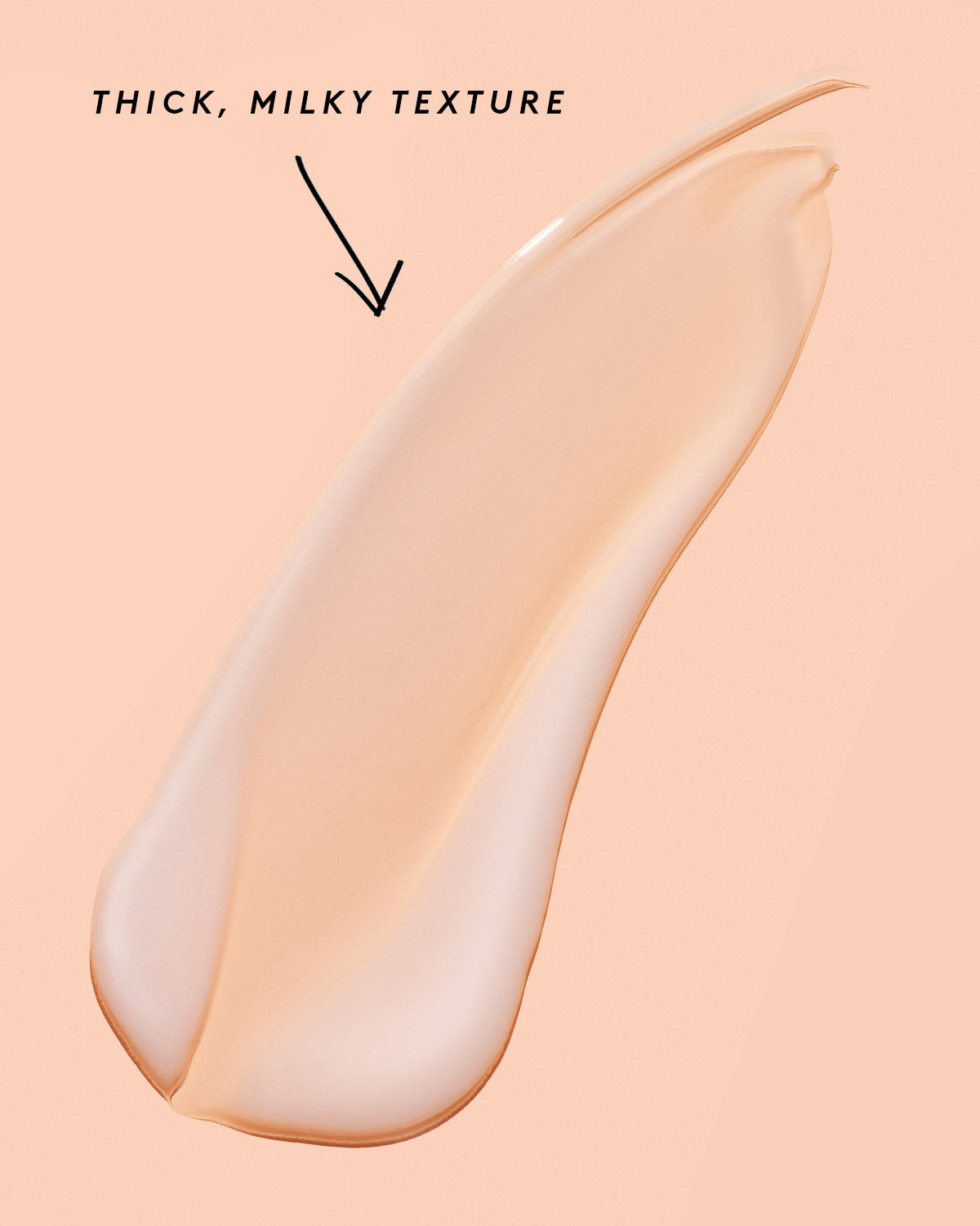 smear of fat water on a peach background noting its thick, milky texture