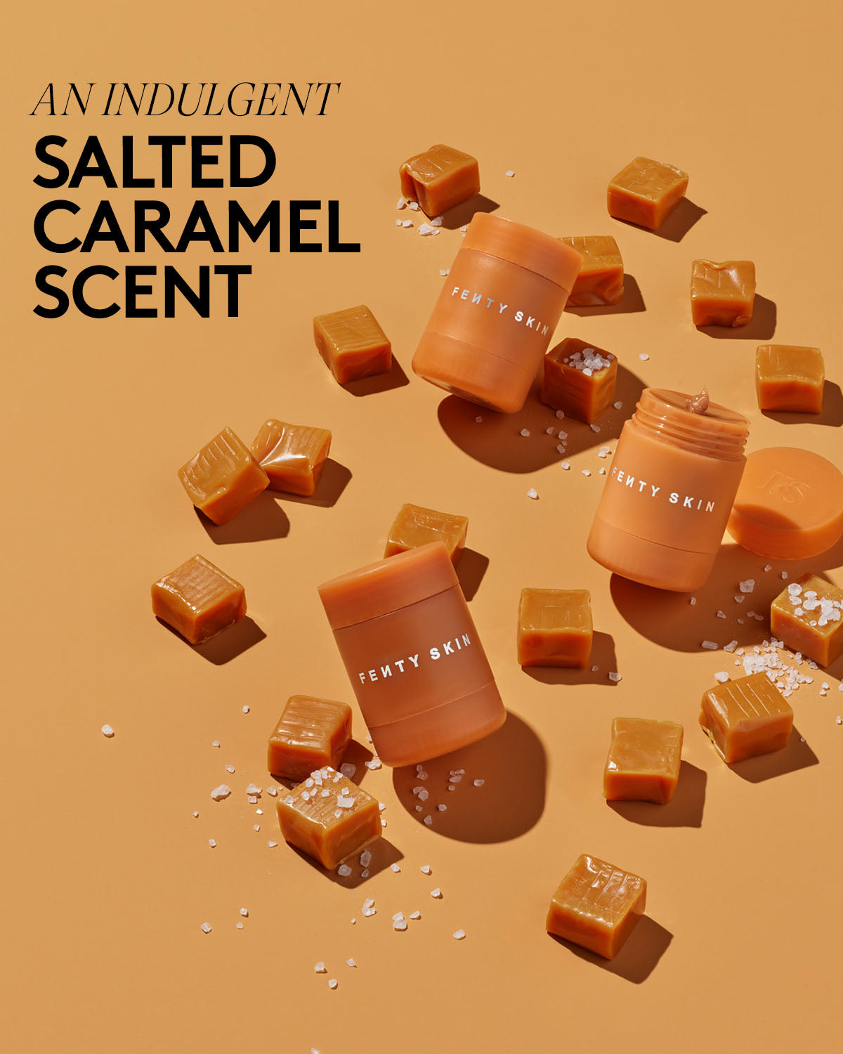 An indulgent salted caramel scent. Product shots of Fenty Skin Plush Puddin' and caramel candies with salt sprinkled over the top.