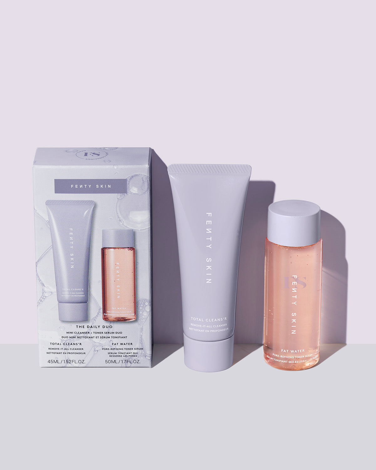 outer packaging and items included in Fenty Skin The Daily Duo Mini Cleanser + Fat Water Toner Serum Duo on lavender background