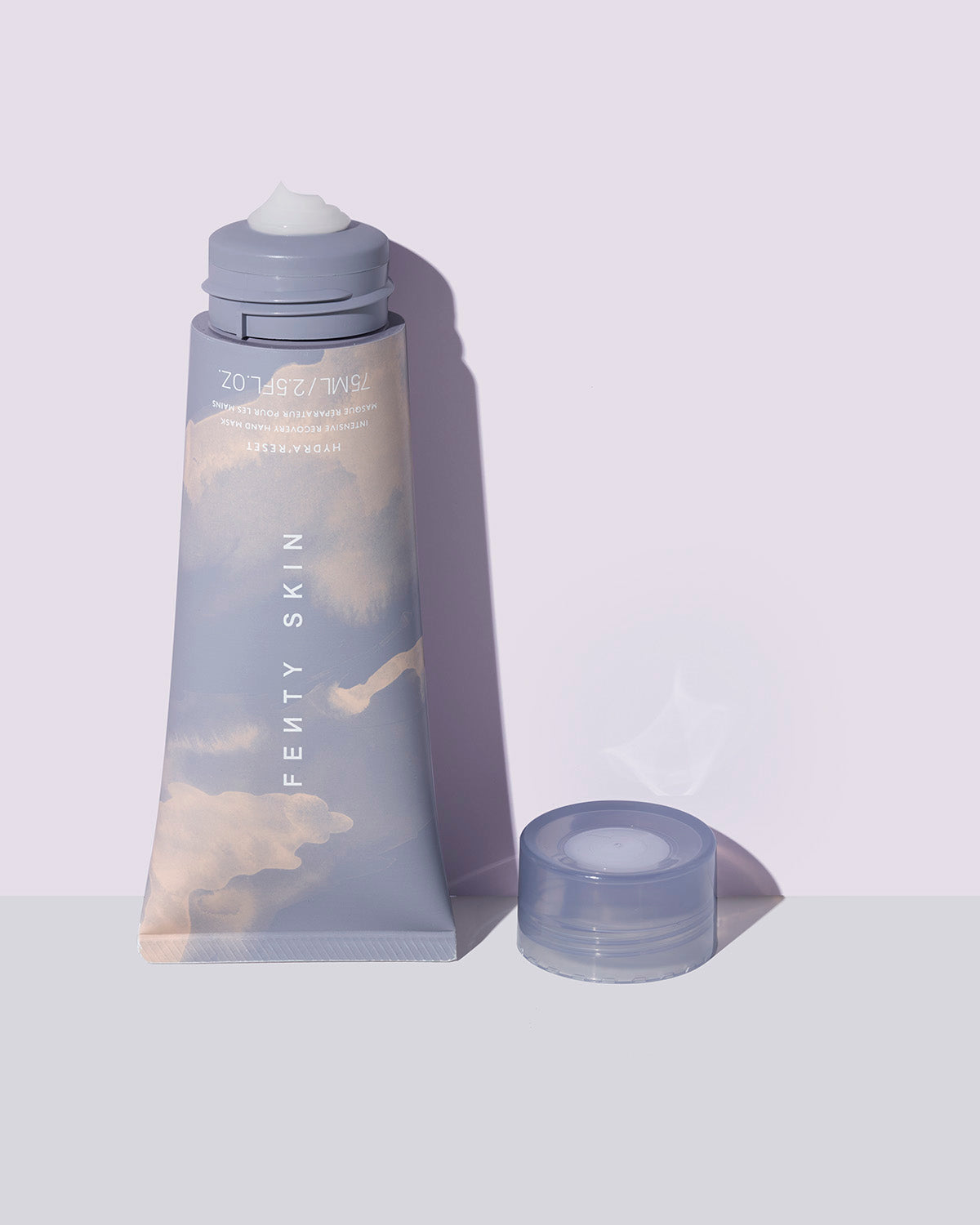 open tube of Fenty Skin Hydra'Reset Intensive Recovery Glycerin Hand Mask on lavender background