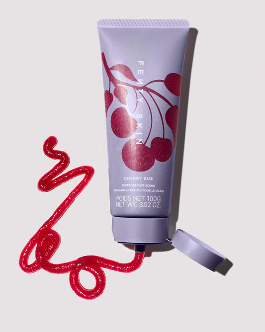 One open bottle of Cherry Dub Superfine Daily Face Scrub squirting some of the product on a light background.