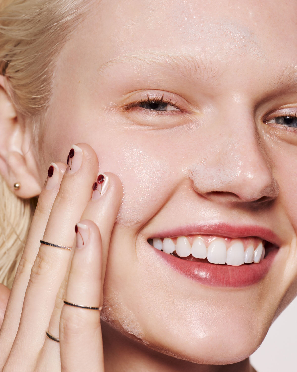 light skin toned model washing face with cherry dub gel cleanser